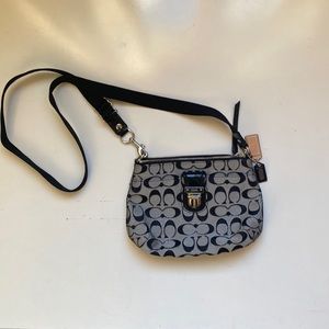 Black and gray coach purse with silver buckle and zipper